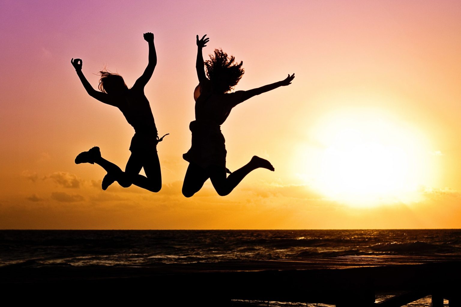 two people jumping in the air