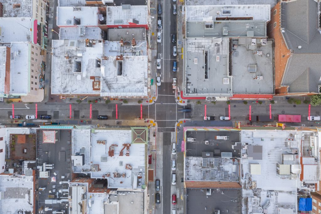 Arial photo from above of San Francisco Chinatown with lanterns spanning Grant Avenue.