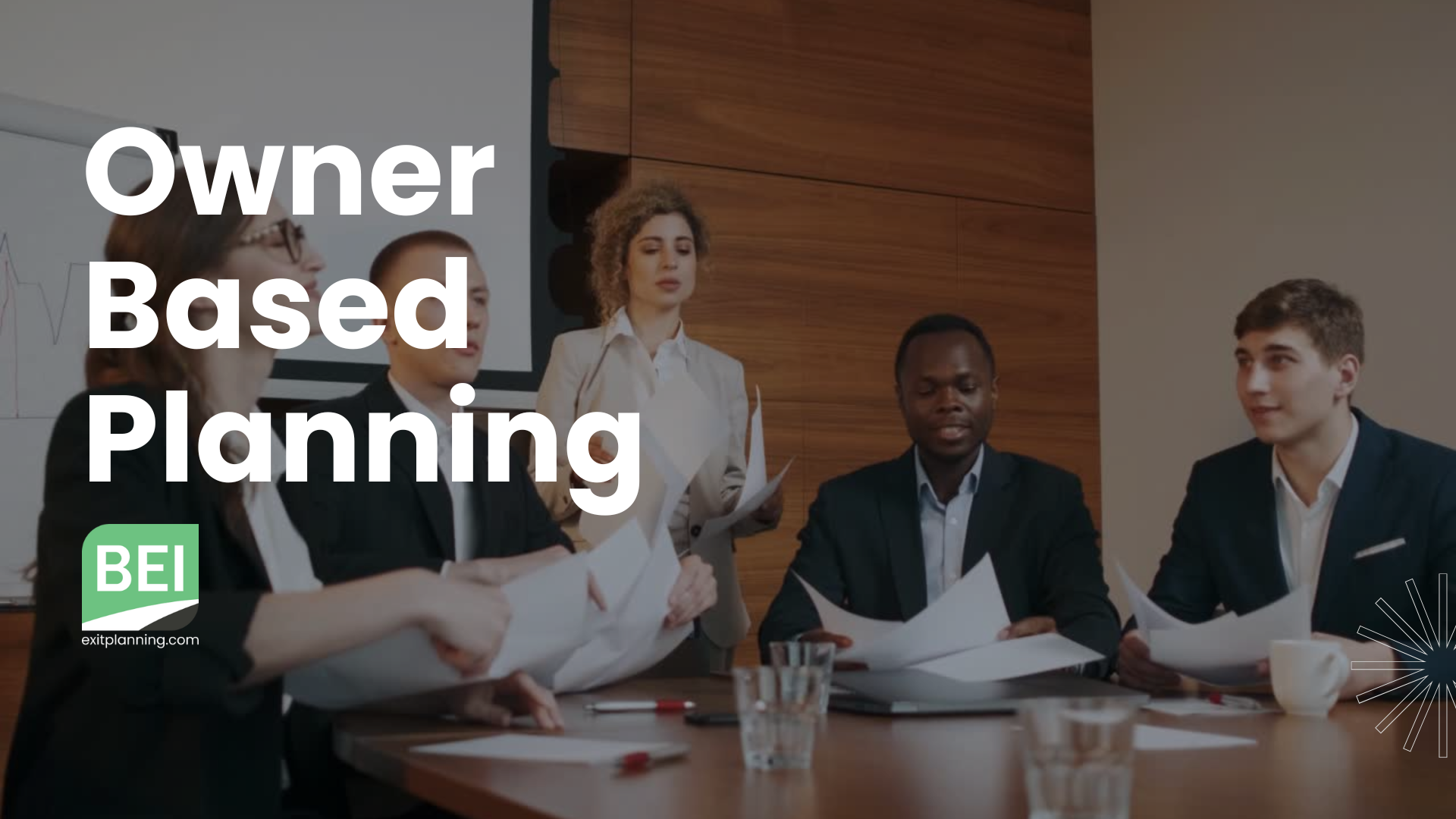A group of people in business attire sitting around a conference table. BEI's Owner Based Planning banner is over the image. 